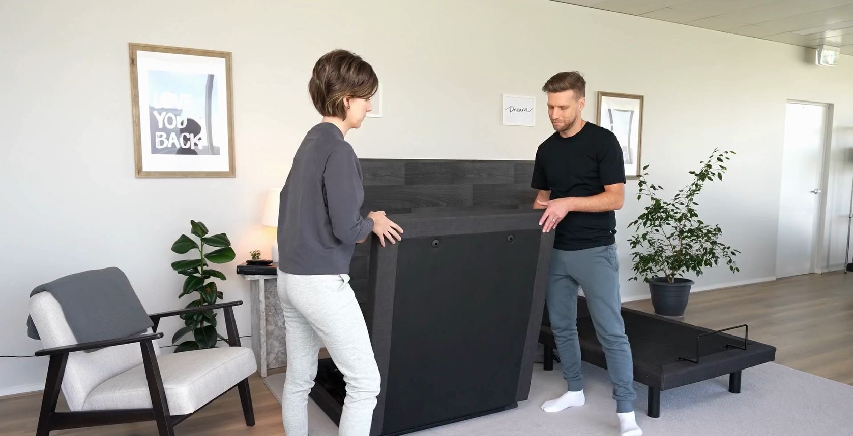 A man and woman are assembling letto bed and mattress