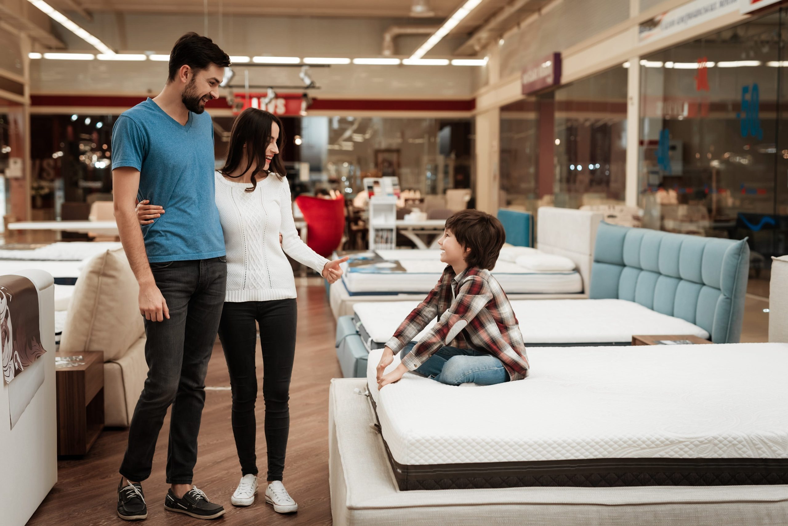 Family testing mattress comfort in store after learning when to change mattress